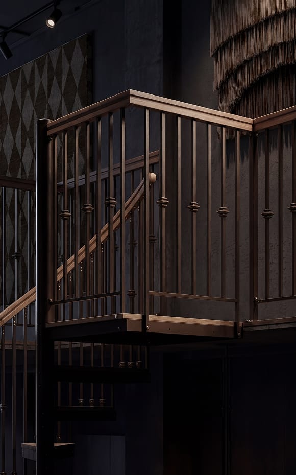 Close-up of a dark bronze spiral staircase landing