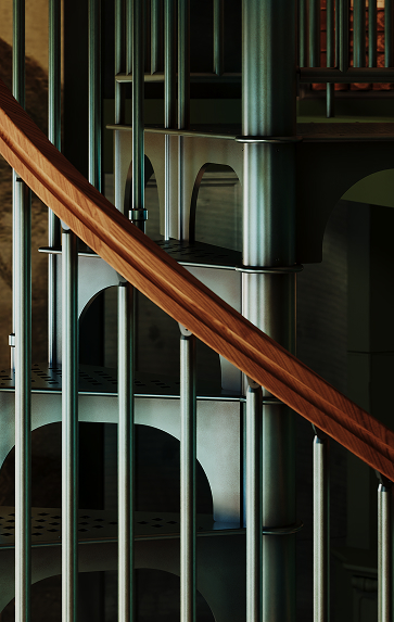 American Industrial spiral staircase wood handrail curving alongside the continuous collars