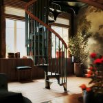 American Industrial spiral staircase with a curved wood handrail in a sunlit reading nook with tall windows