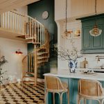 Carpenter oak spiral staircase in an open kitchen with a loft landing and checkerboard tile floor
