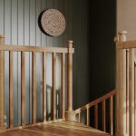 Carpenter spiral staircase landing detail with oak post and spindle railing