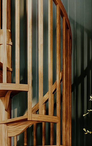 Carpenter spiral staircase with turned oak wood spindles in close-up detail
