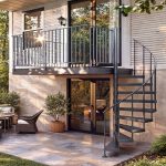 Half Turn spiral staircase in a dark finish connecting a patio to an outdoor balcony