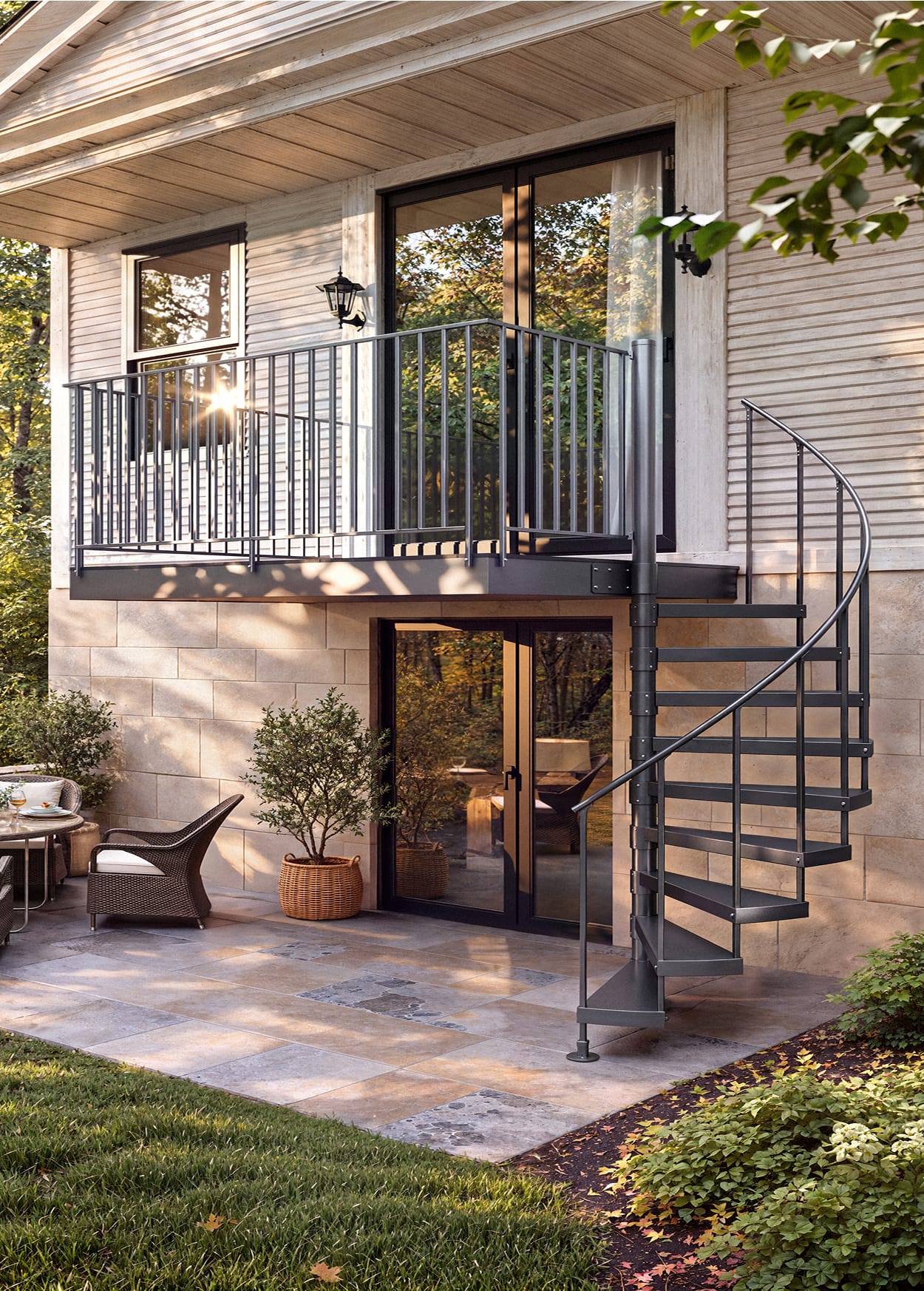 Half Turn spiral staircase in a dark finish connecting a patio to an outdoor balcony