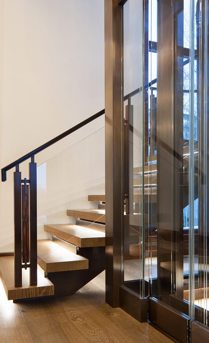 Custom floating staircase with wood treads and frameless glass railing