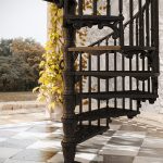 Close-up of Victorian spiral staircase with ornate metal scrollwork
