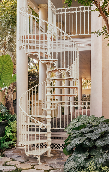 White Victorian spiral staircase with well railing repeating the stair's spindle pattern